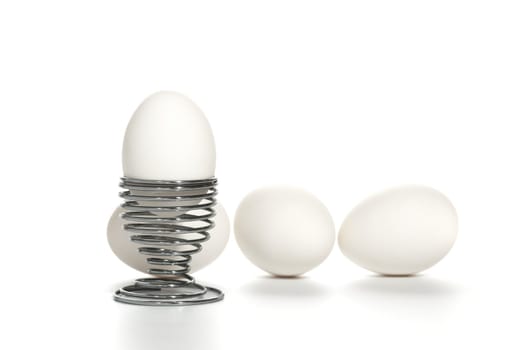white egg on iron stand near by  white egg isolated on white background