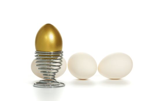 golden egg on iron stand near by white egg isolated on white background