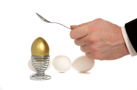 hand broken golden egg on iron stand near by split white egg isolated on white background