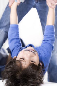 Disabled boy having therapy, hanging upside down