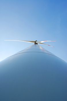 wind turbine under blue sky for alternative energy
