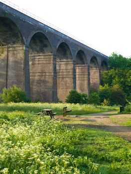 Brick English Victorian Viaduct in Summer With Bench