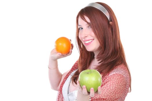Pretty woman with green apple and orange, with copy-space