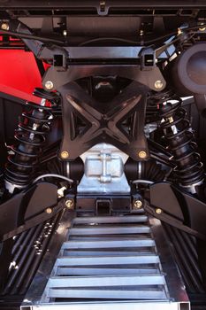 View of independent suspension underneath an all-terrain-vehicle