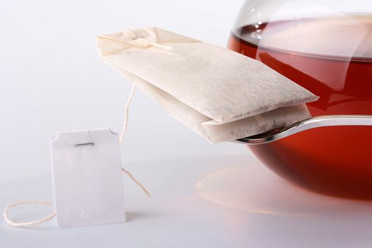 Paper bag with tea on tea spoons, nearby a pure label.
