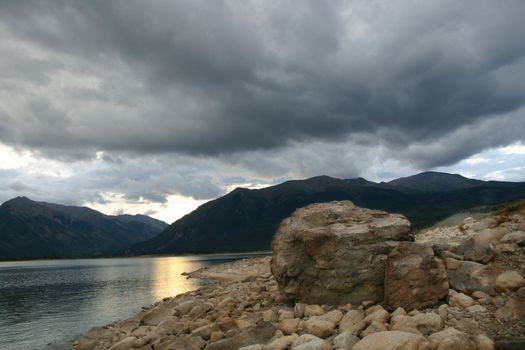 Ominous storm clouds gather over Twin Lakes fishing beach in the Southern Colorado Rocky Mountains