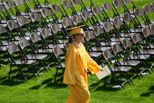 The valedictorian for her graduating class marches to her place at the head of the class.