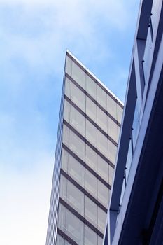 Nice modern glass and steel building on blue sky background