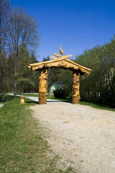A wooden sculpture at the end of the path in the park