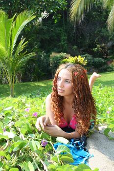 Portrait of woman on beach with plants and grass