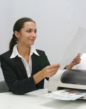 Business woman is prinring in office, copy, duplicate, calling