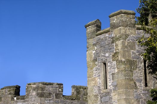 norman battlements and tower against a blue sky in the UK