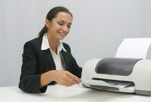 Business woman is prinring in office, copy, duplicate, calling