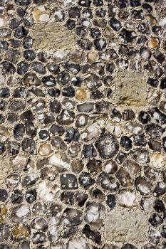 Close up of the outer wall of an English medieval castle made of flint