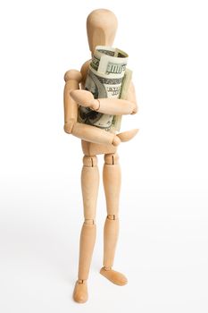 The wooden figure holds dollars.Isolated on white [with clipping path].