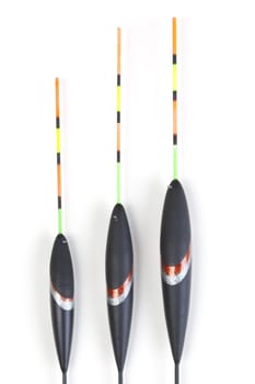 Image of fishing bobbers on reflective surface