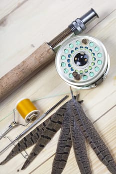 Fly fishing rod and reel with a silver popping bug