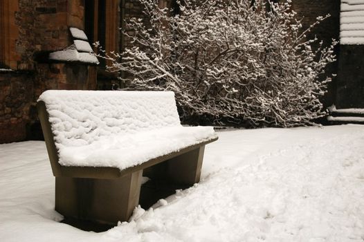 bench at the Cardiff cathedral covered by snow