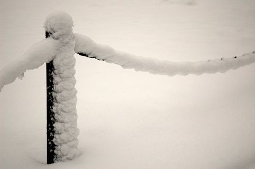 guardrail covered by snow, horizontally framed shot