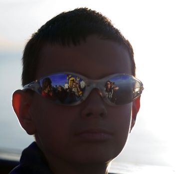 the boy wearing sunglasses in the summer