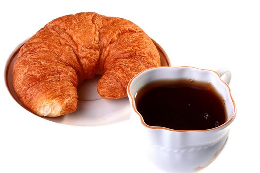 Cornetto on a saucer with a cup of black tea.