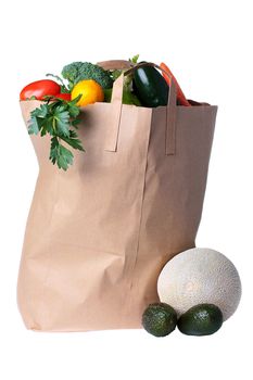 The big paper package with vegetables after visiting of shop trading in products.