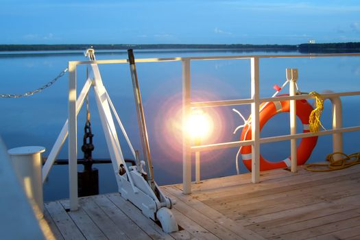 anchor, lamp and life buoy on a lower deck      
