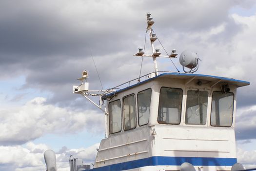 pilot-house of little ship on a background sky with clouds         