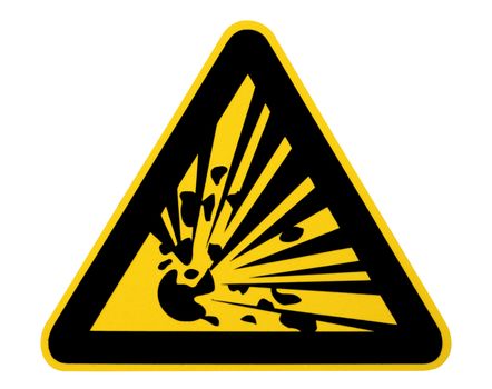 A yellow triangular sign warning of explosive material, photographed close-up and isolated on white. Clipping path included.