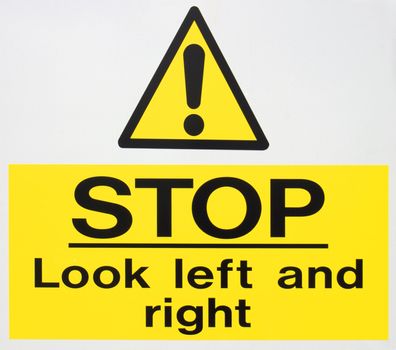 A sign warning motorists to stop and look both left and right.