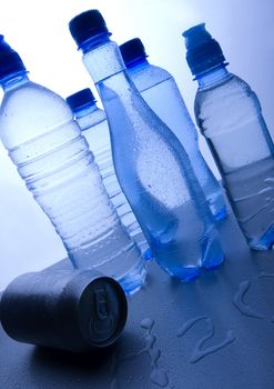 Bottles of mineral water on blue background