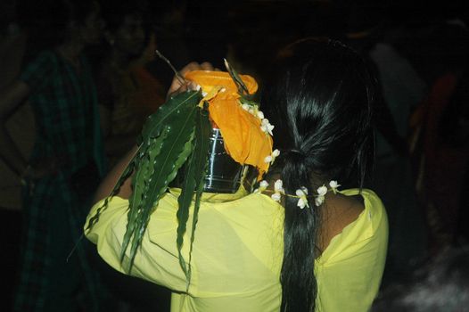 Devotee carrying milk container at thaipusam festival