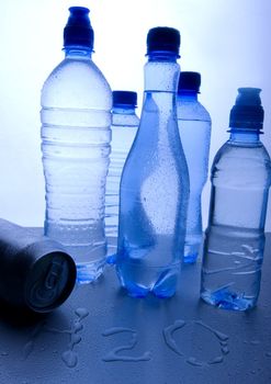 Bottles of mineral water on blue background