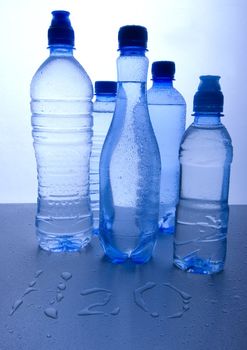 Bottles of mineral water on blue background