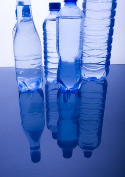 Bottles of mineral water on blue background