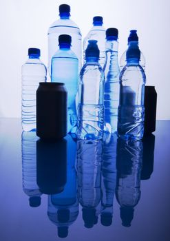 Bottles of mineral water on blue background