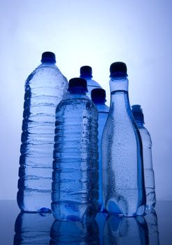 Bottles of mineral water on blue background