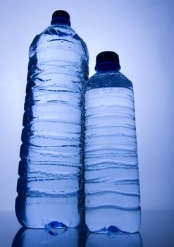 Bottles of mineral water on blue background