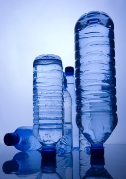 Bottles of mineral water on blue background