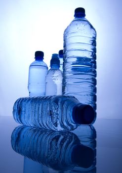 Bottles of mineral water on blue background