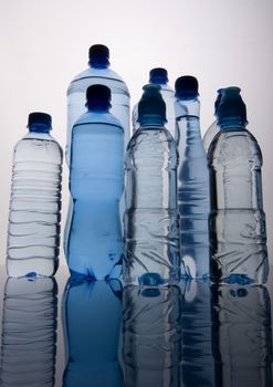 Bottles of mineral water on blue background