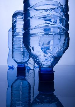 Bottles of mineral water on blue background