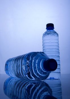 Bottles of mineral water on blue background