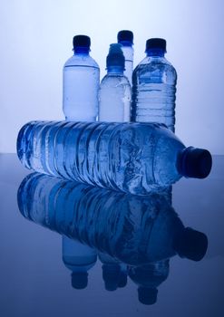 Bottles of mineral water on blue background