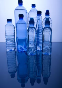 Bottles of mineral water on blue background