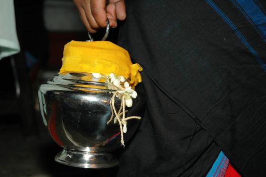 Close up of devotee carrying milk pot as offering for Lord Murugan at Thaipusam