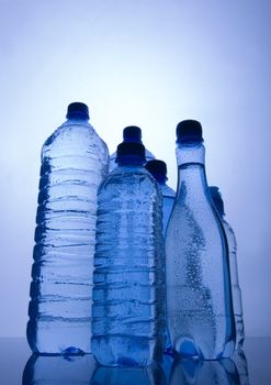 Bottles of mineral water on blue background