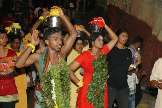 Devotees carrying milk pots at Thaipusam event celebrating Lord Murugan