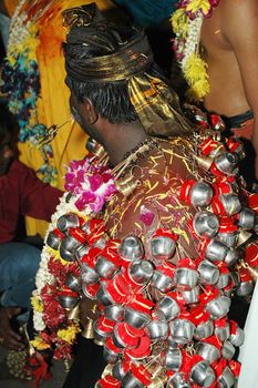 Devotee with piercing at Thaipusam event celebrating Lord Murugan