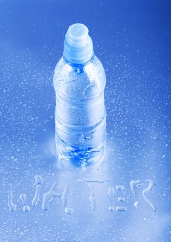 Bottle of mineral water on blue background